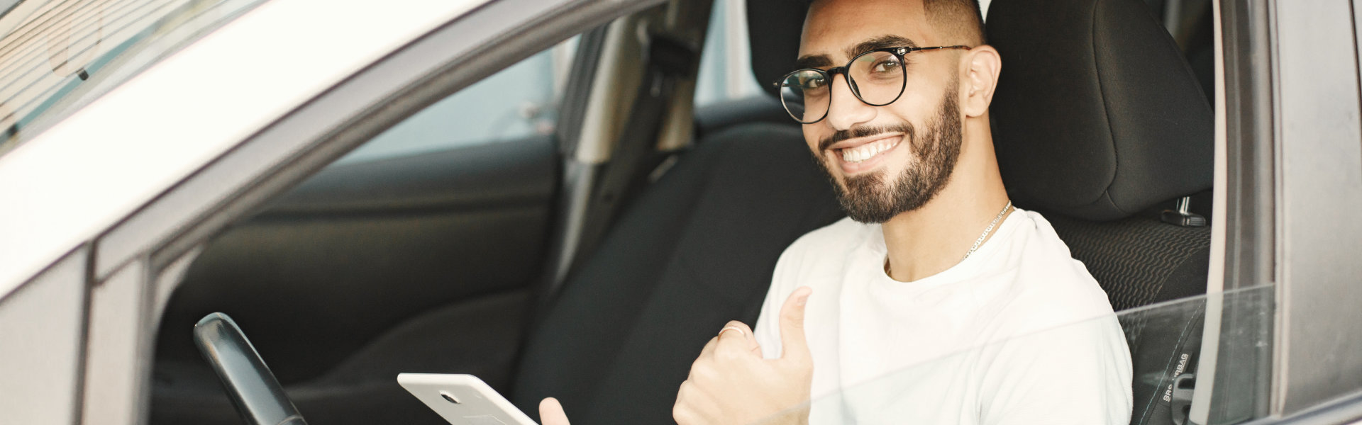 man smiling inside car
